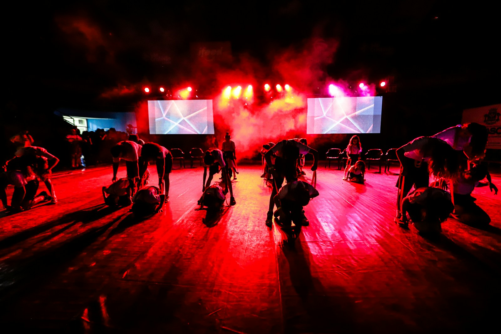 a group of people standing on top of a wooden floor