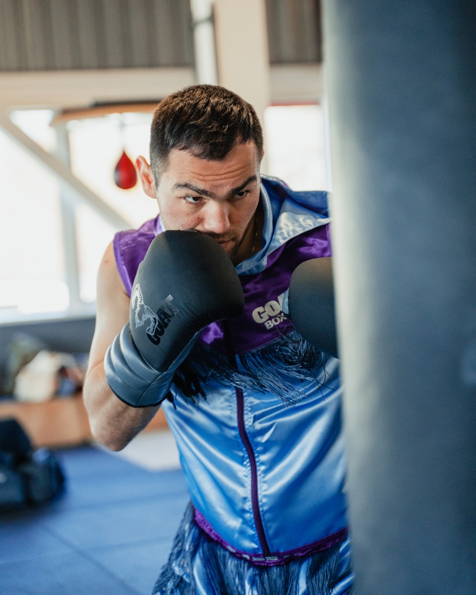A man in a boxing ring with a punching glove